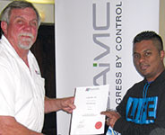 Andre Ramroop (right) being presented with his membership certificate.
